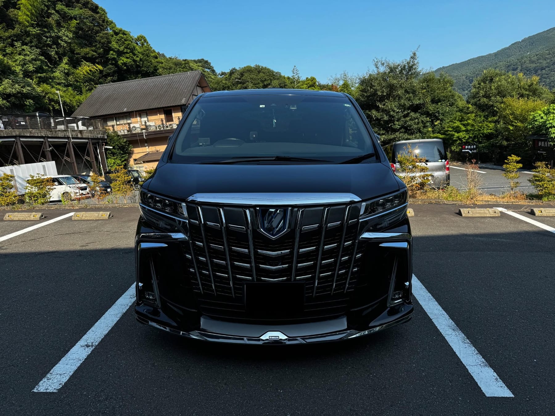 Toyota Alphard luxury MPV front view at a scenic stop in Hakone