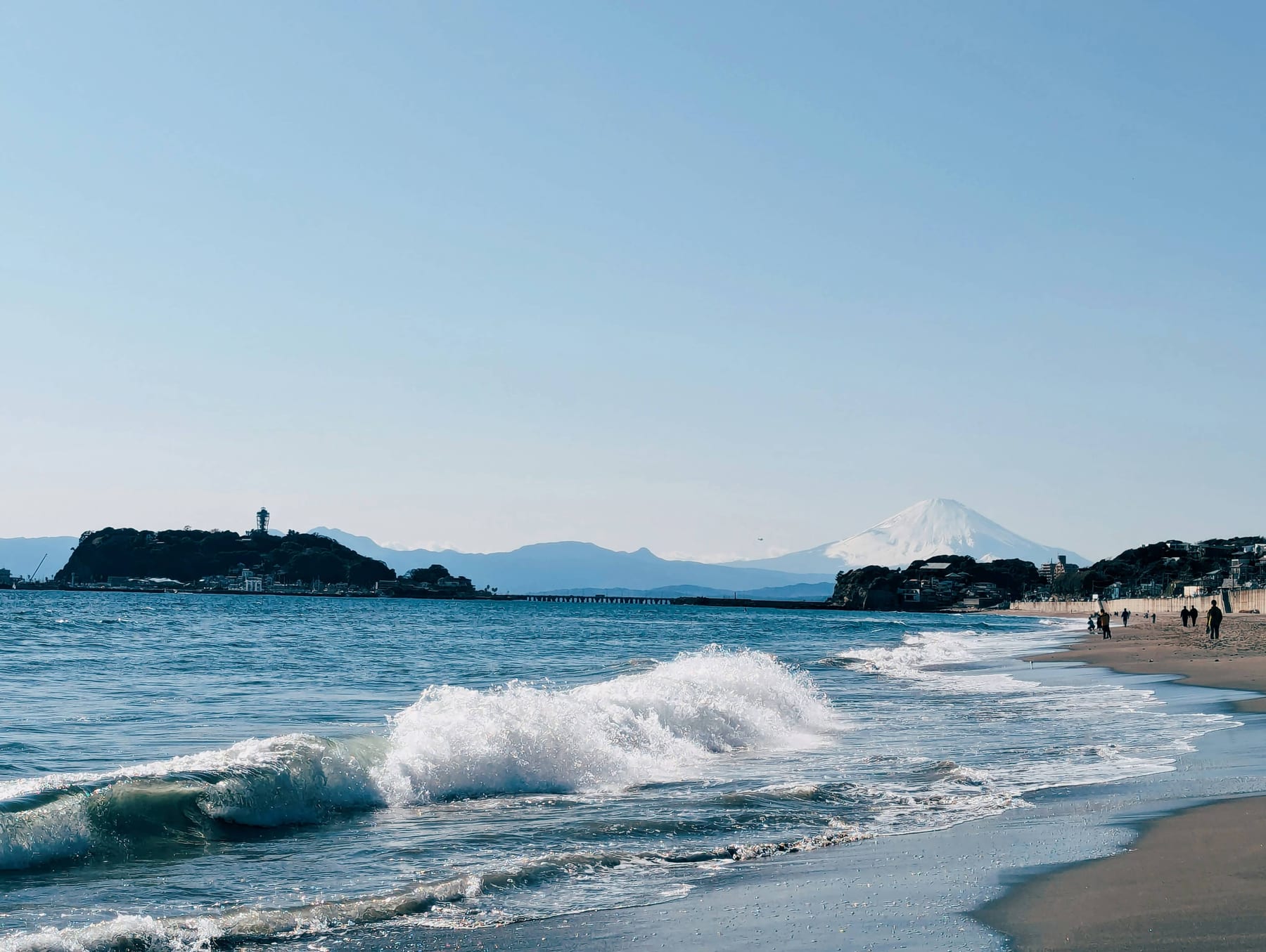 Mount Fuji seen across the open water from a beach near Enoshima and Kamakura on a clear day