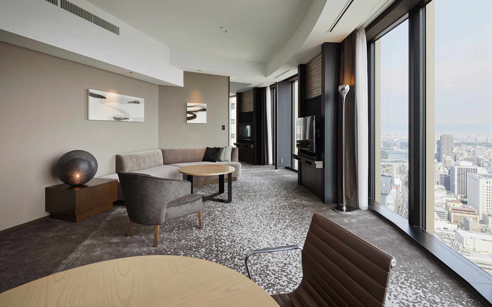 A corner suite at Conrad Osaka with floor-to-ceiling river views