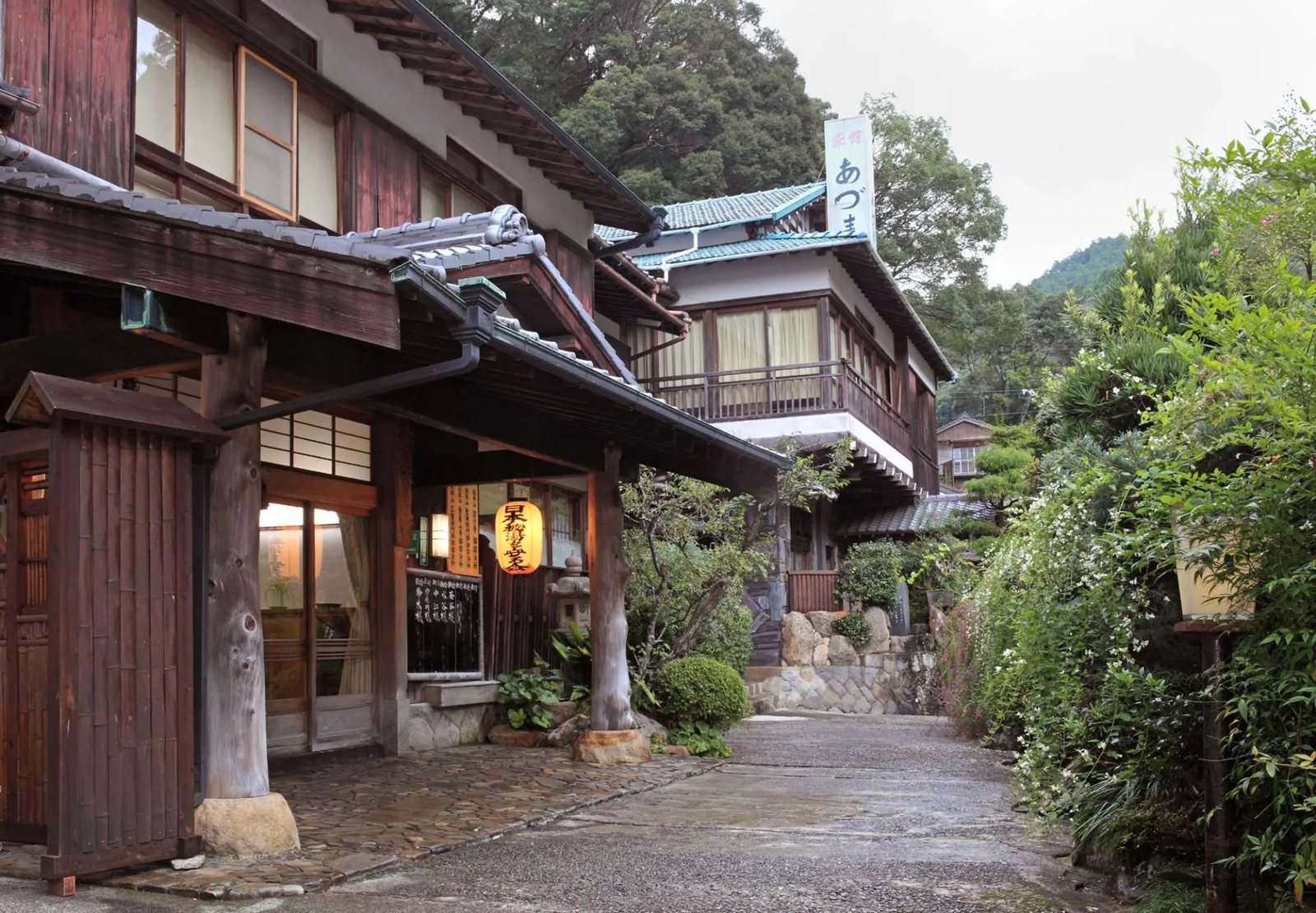 The lantern-lit wooden front of Ryokan Adumaya in the lanes of Yunomine Onsen