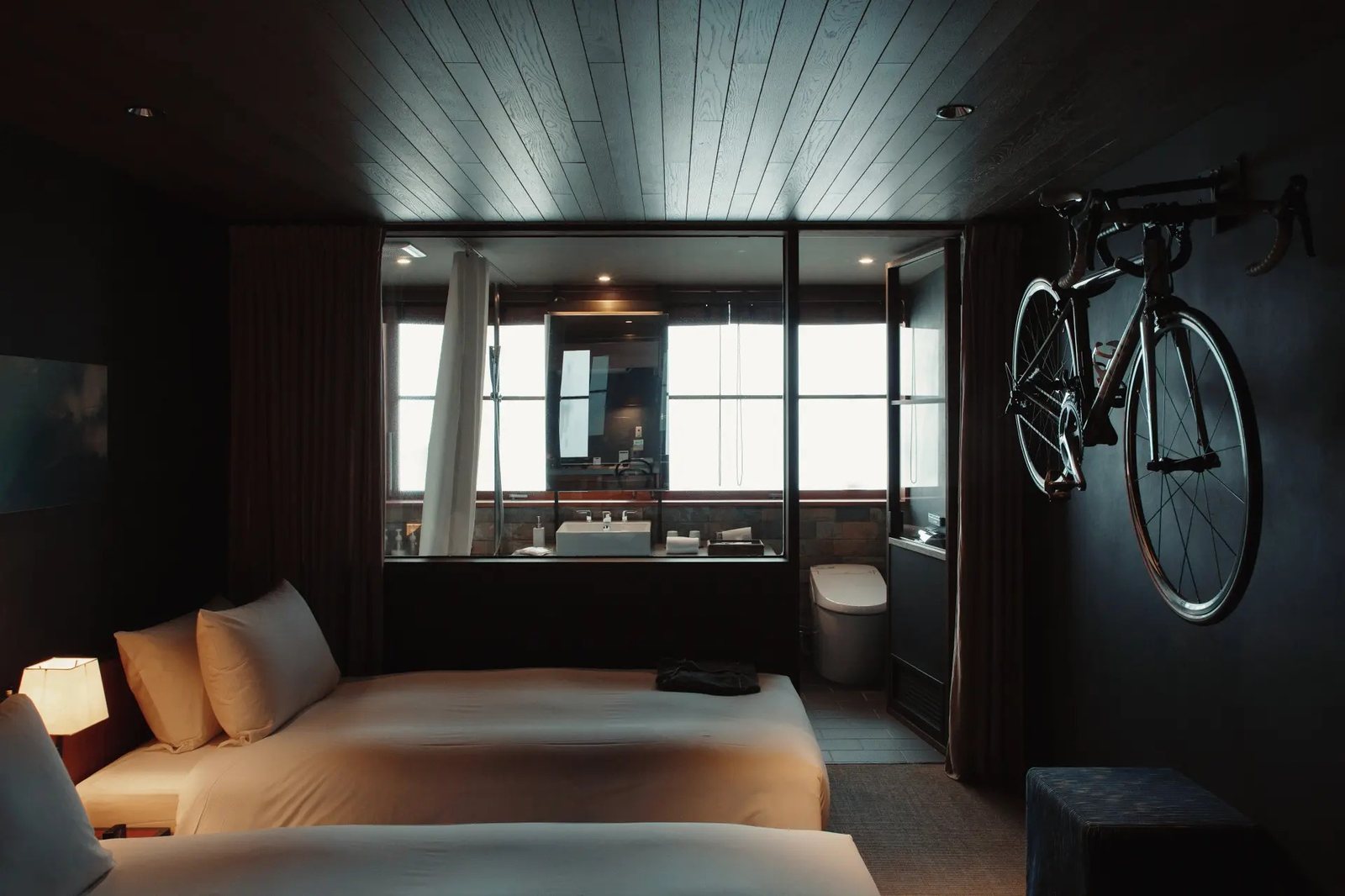 A guest room at Hotel Cycle with a bicycle hung on the wall