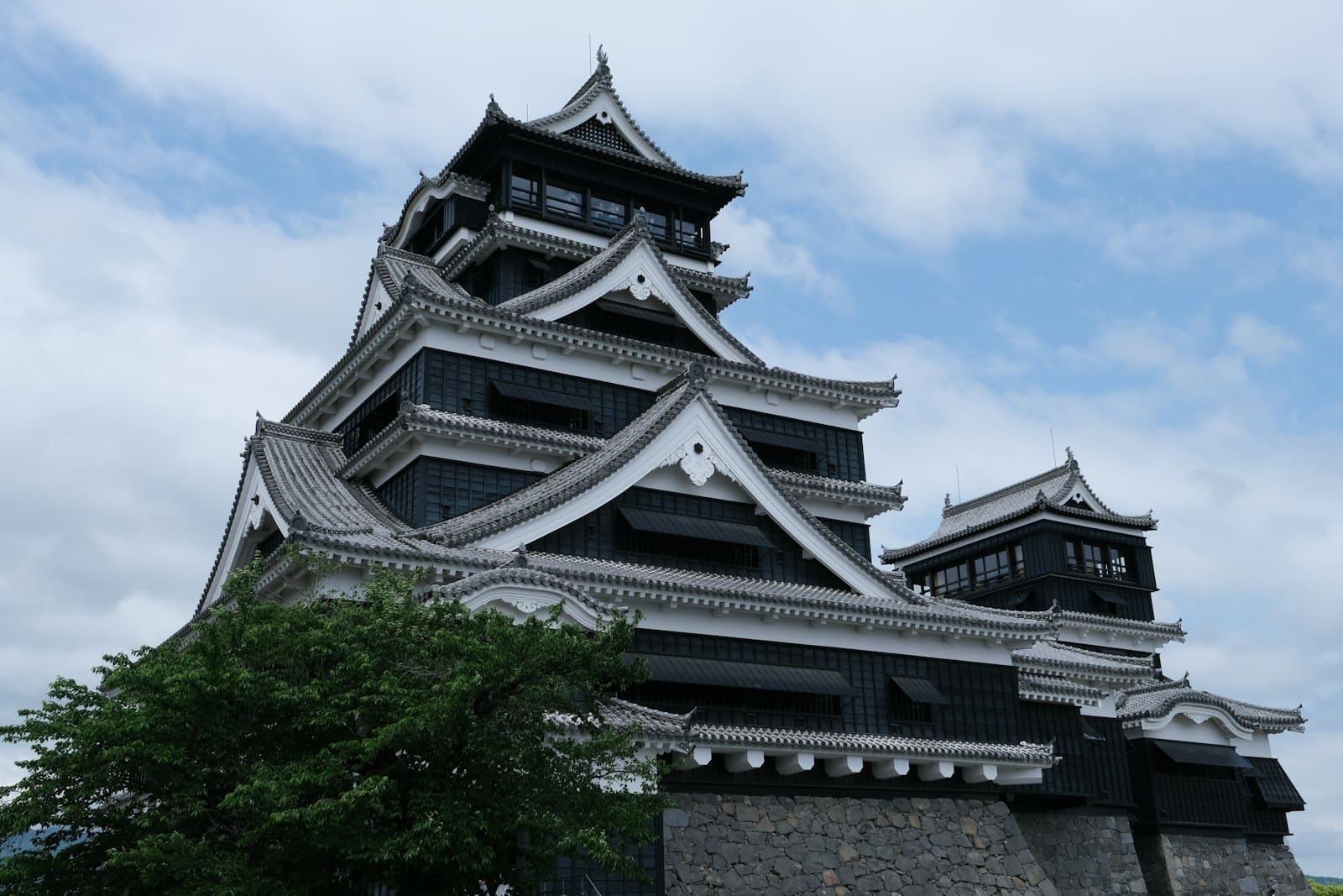 The black keep of Kumamoto Castle above its stone ramparts