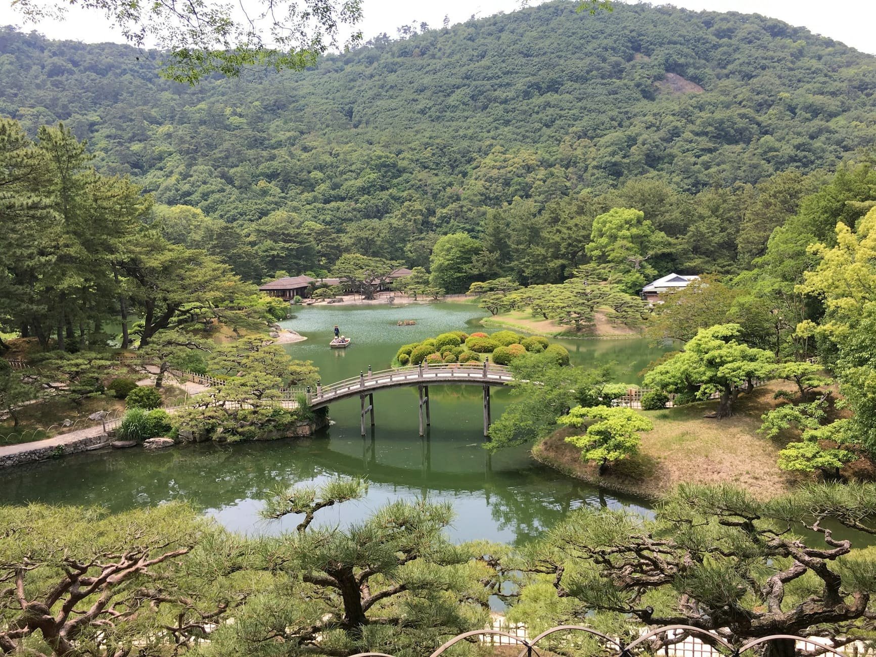 A pond and arched bridge in a pine garden in Takamatsu