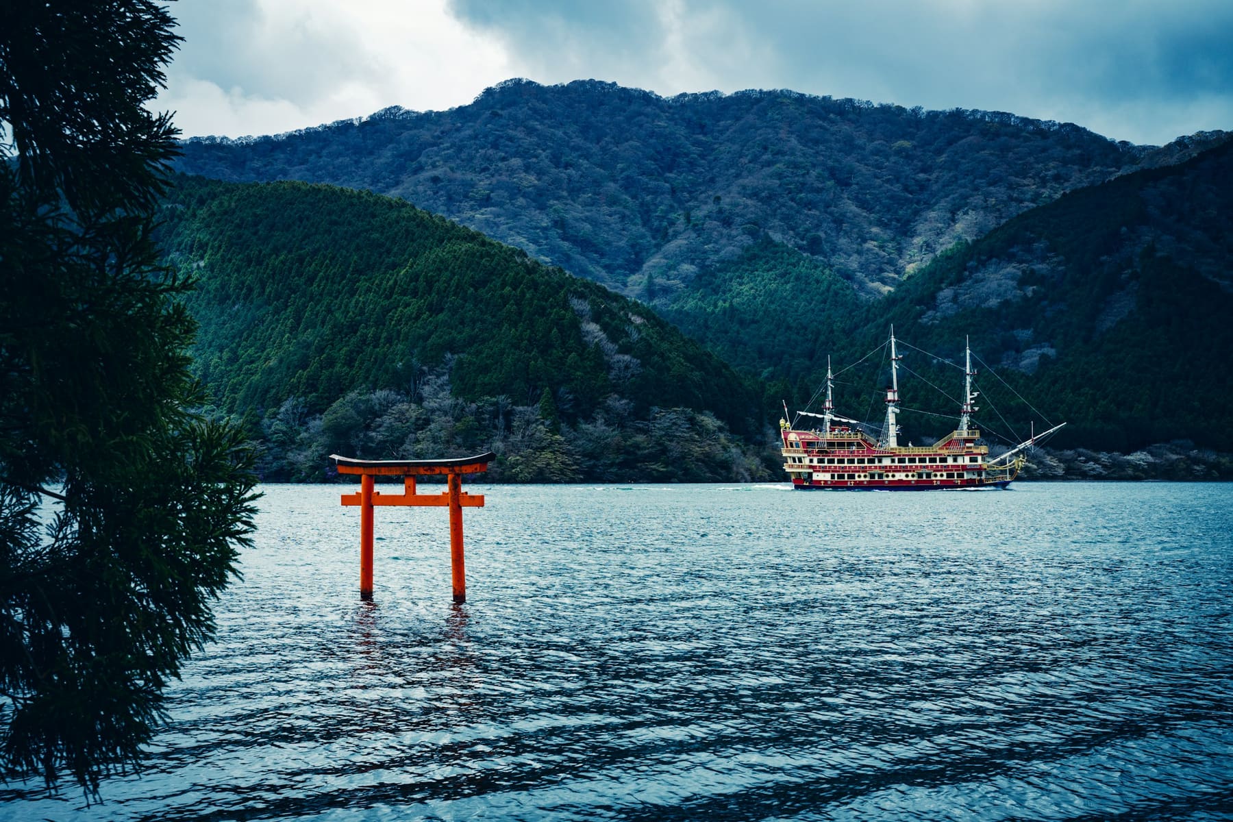 The red torii gate on Lake Ashi with a sightseeing ship beyond, Hakone