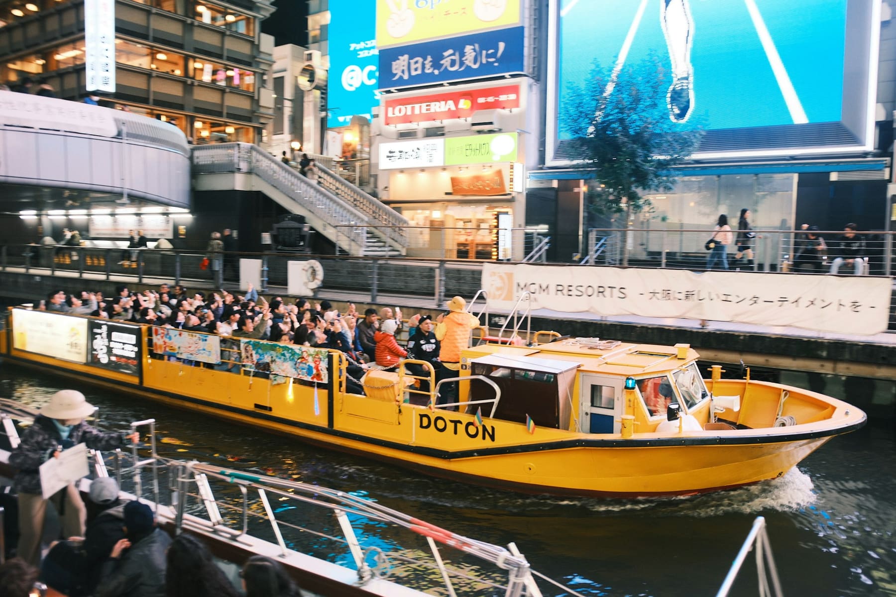A sightseeing boat on the canal beneath the neon of Dotonbori, Osaka